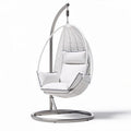 Hanging egg chair with cushioned seating in white rattan and steel frame